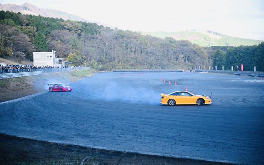 Two cars are in the race circuit.