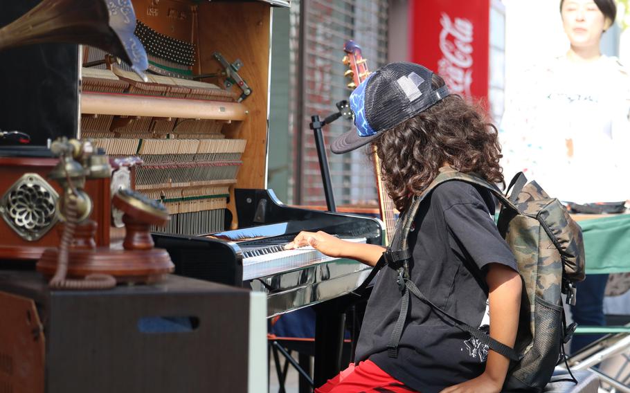 a person playing the piano on the street.