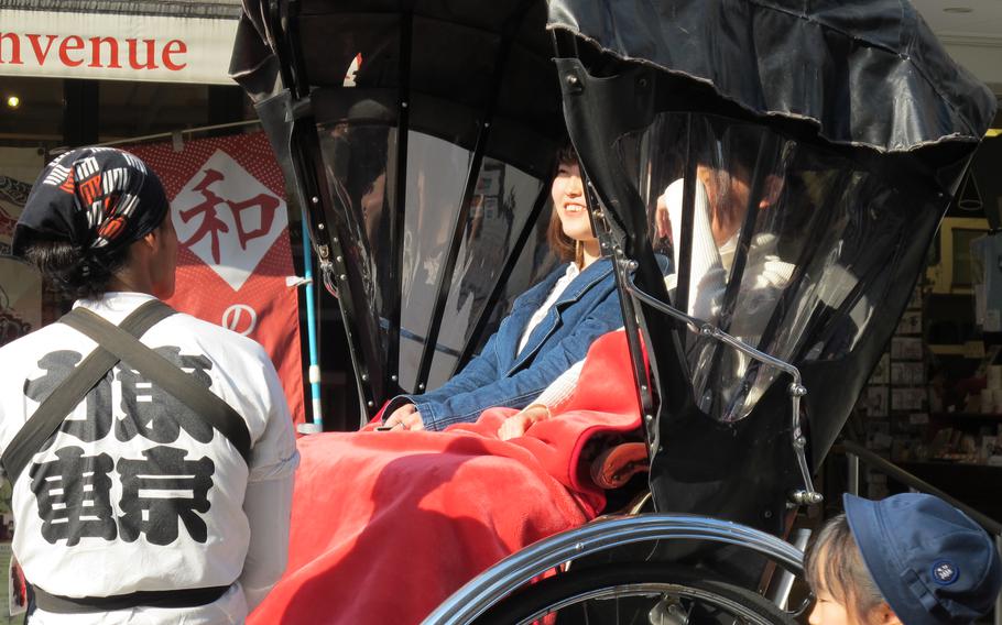 Two people are taking a rickshaw.