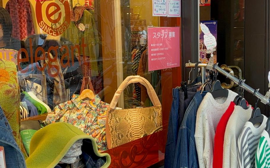 An outside of a general store selling clothing and bags.