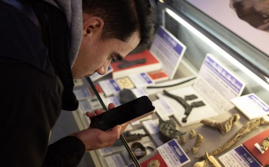 a man taking a photo of an exhibition.