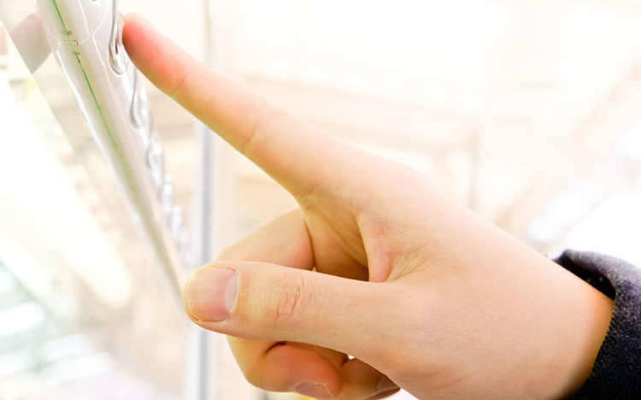 a person pressing one of the buttons on a vending machine.