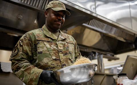 Photo Of U.S. Air Force Staff Sgt. Kenneth Bradshaw, 35th Force Support Squadron food service shift leader, tosses spices for prime ribs in a bowl at Misawa Air Base, Japan, June 6, 2025.