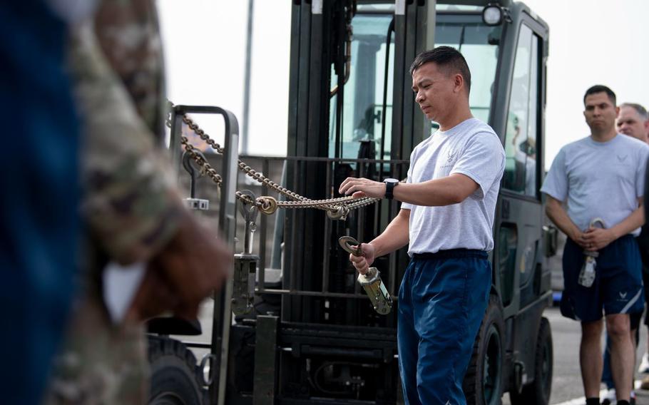 Tech. Sgt. Ephraim Oliva installs a device on a chain.