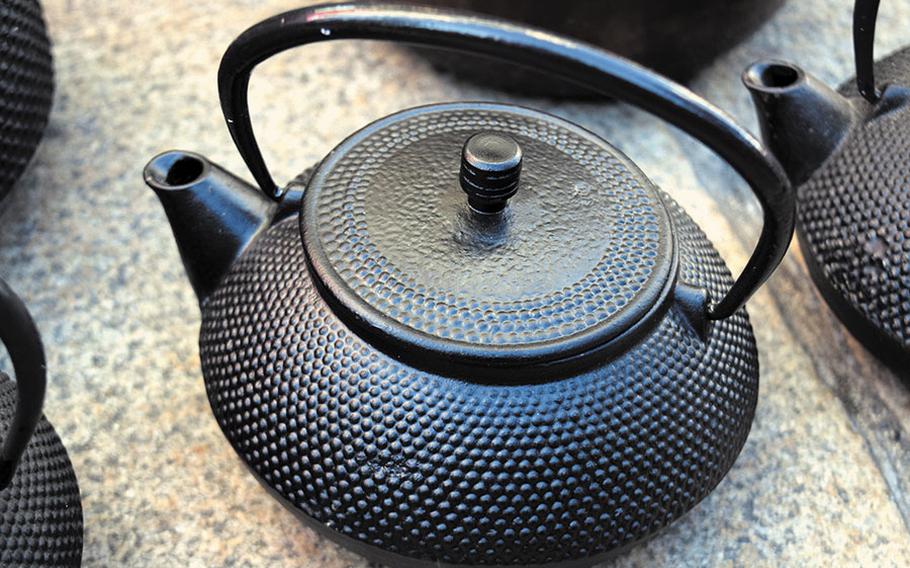 A small metal teapot.