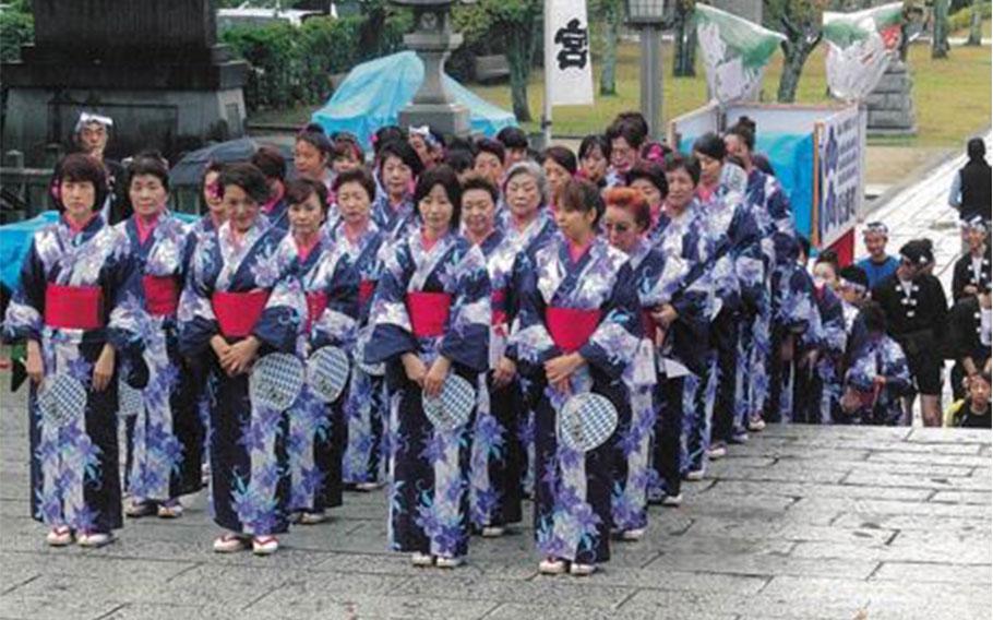 Females are standing waiting for their turn to dance.