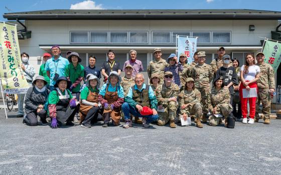 U.S. Air Force and Japanese National volunteers pose for a photo during a city beautification project in Fussa, Japan, May 13, 2025. Fussa is one of the cities surrounding Yokota Air Base, and offers volunteer opportunities for beautification projects every spring and fall.