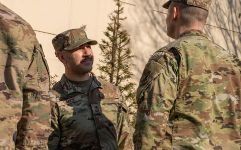 Photo Of Chief Master Sgt. Kenneth Hauck inspects Airmen’s uniforms.