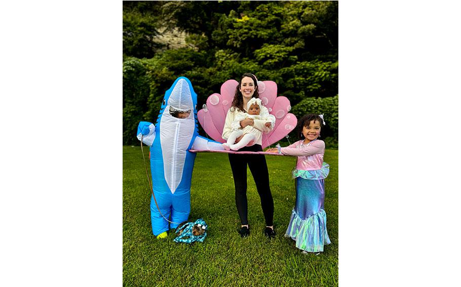 a family wearing costume of shark, mermaid, and shellfish.