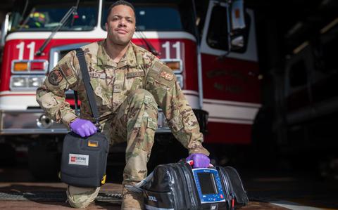 Photo Of U.S. Air Force Senior Airman Derek Hinton holds medical equipment.