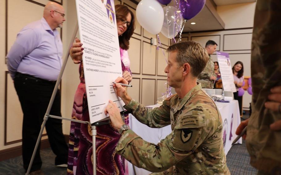 Col. Marcus Hunter, commander of U.S. Army Garrison Japan, signs a proclamation during the Domestic Violence Awareness Month kickoff event Oct.1 at the Camp Zama Community Club. Camp Zama’s Army Community Service hosted the event. 