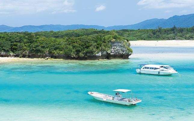 two ships can be seen near the beach.
