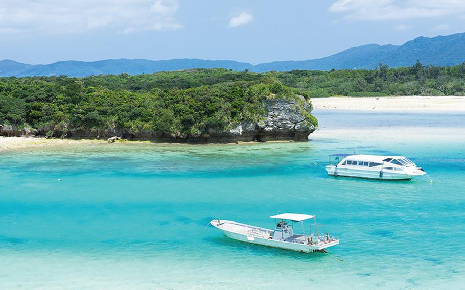 two ships can be seen near the beach.