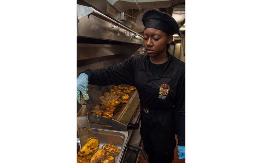 Culinary Specialist Seaman Apprentice Vashti Randolph, from Seattle, grills chicken in the wardroom galley aboard the U.S. Navy’s only forward-deployed aircraft carrier, USS Ronald Reagan (CVN 76), while in-port Commander, Fleet Activities Yokosuka, March 8. Ronald Reagan, the flagship of Carrier Strike Group 5, provides a combat-ready force that protects and defends the United States, and supports alliances, partnerships and collective maritime interests in the Indo-Pacific region. 