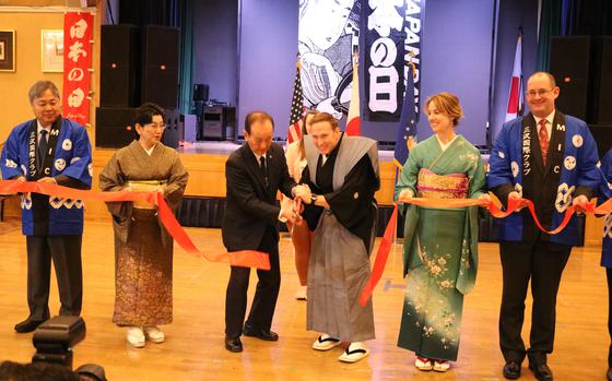 people cutting the ribbon.