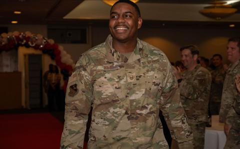 Photo Of Master Sgt. Tommy Rowe walks down to accept a plaque