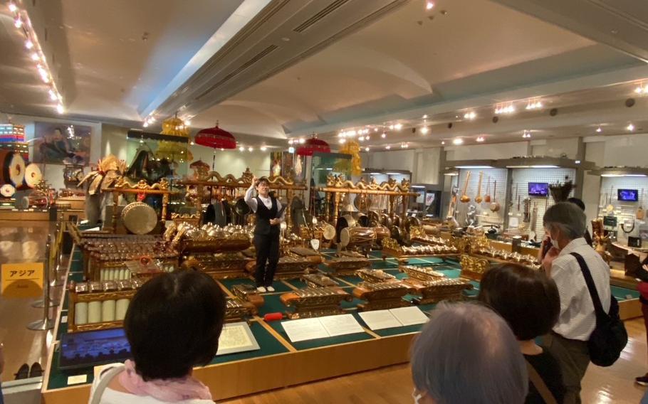One of the staff memebers explains about instruments before she demonstrates and performs instruments.