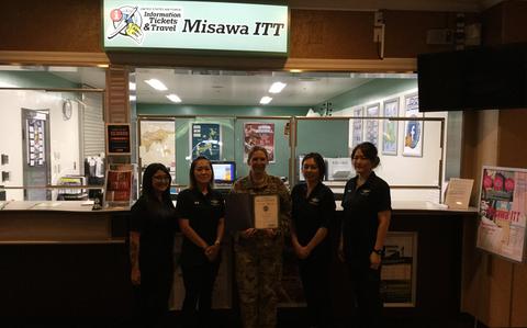 Photo Of Misawa ITT staff group photo as Stars and Stripes Pacific Commander Lt. Col. Marci Hoffman presents award.