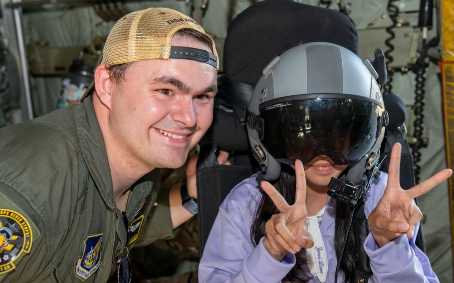 U.S. Air Force Senior Airman Blake Jassen, 36th Airlift Squadron loadmaster, poses for a photo with a community member at the 2024 Japanese-American Friendship Festival at Yokota Air Base, Japan, May 18, 2024.