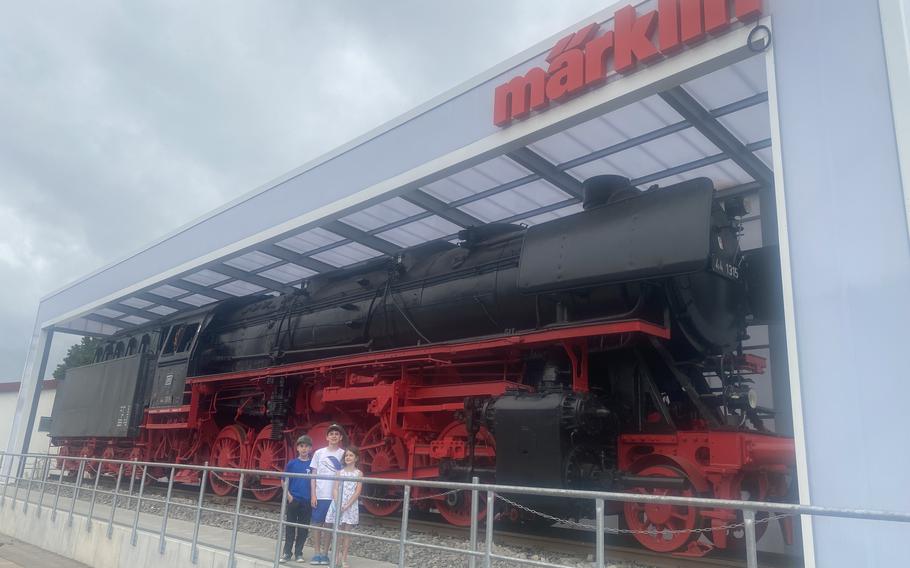 Richard and his siblings pose for a photo in front of a steam train.
