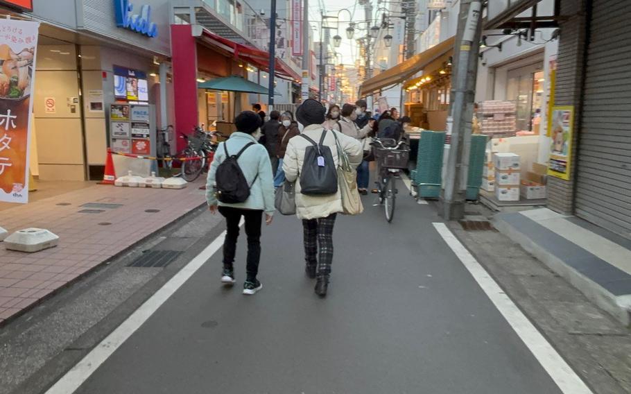 some people walking in the street.