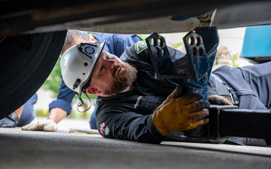 Barret Godfrey, WreckMaster contracted instructor, performs a demonstration on how to attach a vehicle to a wrecker at Misawa Air Base, Japan, Aug. 28, 2024. WreckMaster training aimed to help wrecker operators remain safe and retrieve vehicles in different scenarios at Misawa Air Base.