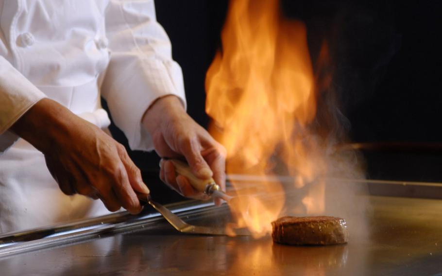 chef grilling beef on teppanyaki