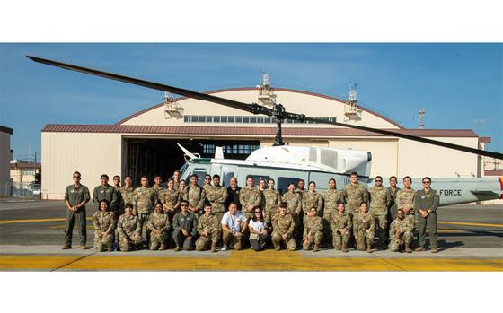 Photo Of In sunny weather, about 40 participants of the National Hispanic Heritage Month orientation flight pose for a photo in front of a UH-1N Huey assigned to the 459th Airlift Squadron at Yokota Air Base, Japan, Oct. 2, 2024