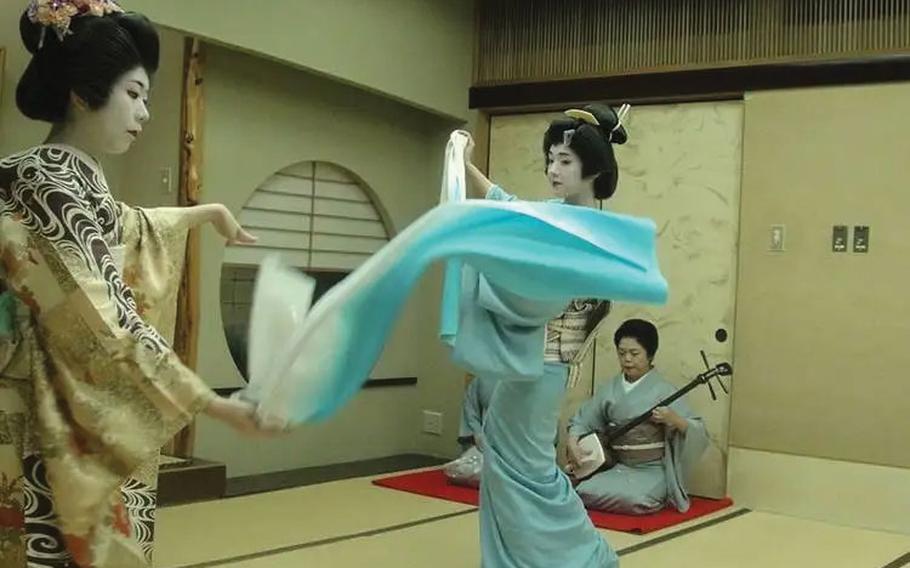 Geisha are dancing and playing the instrument.