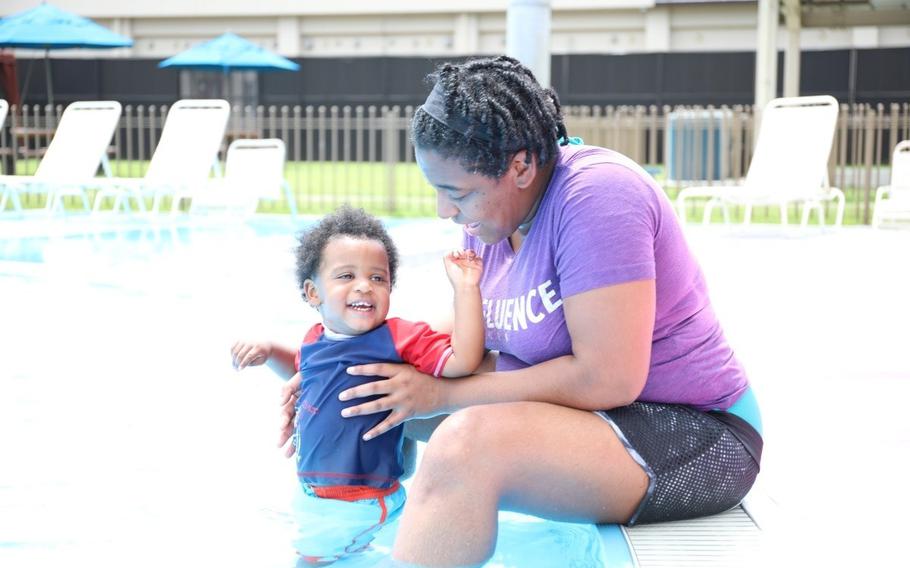 ShanDreaha “Shay” LaNedtra Hudak plays with her son at the Sagamihara Housing Area outdoor swimming pool July 19 during an Army Community Service-hosted child-parent bonding pool playgroup.