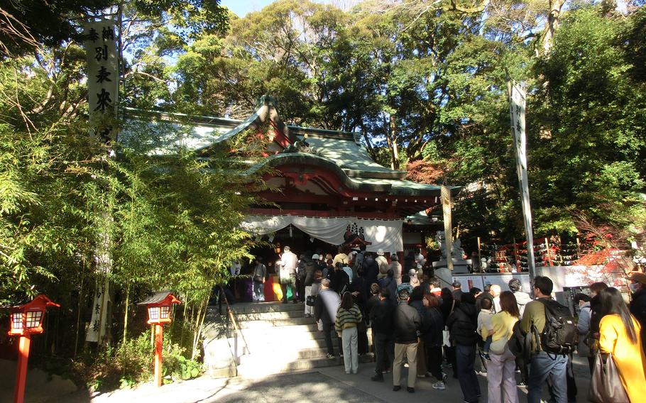 Visitors make a line to press the palms and fingers of both hands together at Kinomiya Shrine