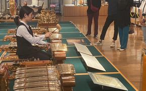One of the staff members demonstrates and performs an instrument.