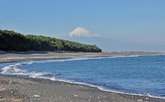 mt. fuji can be seen from the beach.