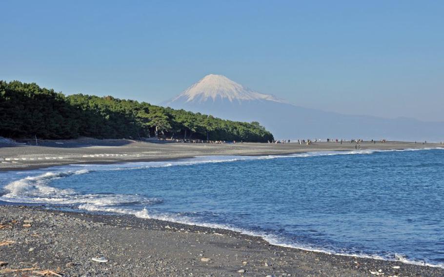 mt. fuji can be seen from the beach.