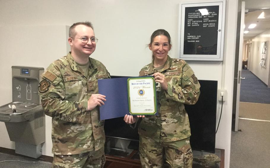 Stars and Stripes Pacific Commander Lt. Col. Marci Hoffman presents award to SSgt Benjamin Bugenig (DJ Bugaboo)