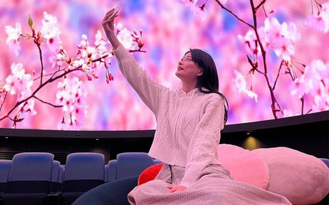 Photo Of a woman taking photos in the planetarim.