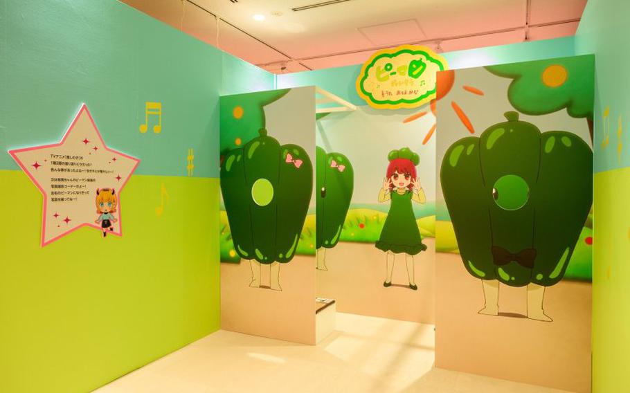 one of the characters and illustrations of some green peppers are exhibited on the wall.