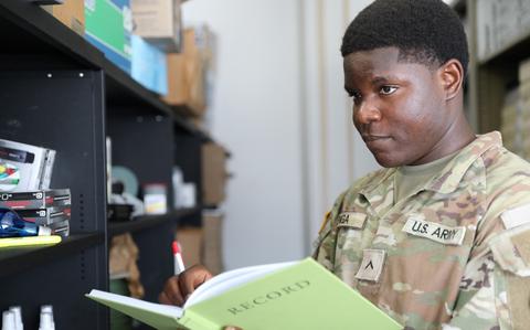 Photo Of Pfc. Franck Karel Penga Nkweya conducts an inventory.