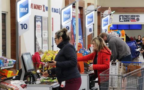 Photo Of Shoppers use self-service checkout.