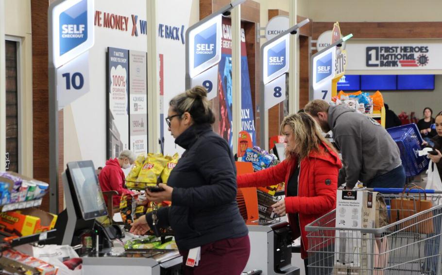 Shoppers use self-service checkout.