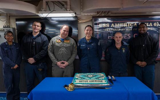 Capt. Manuel Pardo stands with the ship’s diversity committee before cutting the cake 