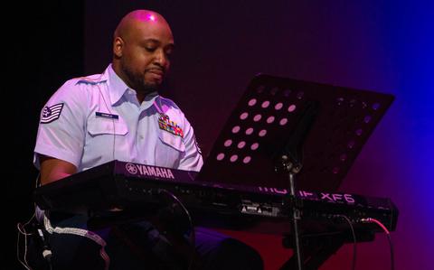 Photo Of ech. Sgt. David Dormeus playing the piano during the concert.