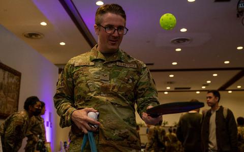 Photo Of USAF Senior Airman Henry Gergen plays with a pickleball racket and ball during the club expo at Yokota Air Base, Japan, Nov. 6, 2024.