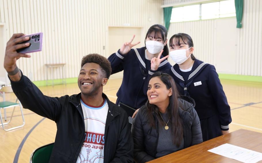 Camp Zama volunteers and students pause to take a photo together during an English Challenge Day held March 5 at Nishi Junior High School.