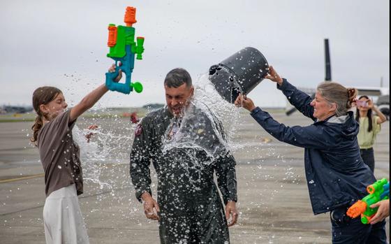 U.S. Marine Corps Col. Richard Rusnok is being splashed water on.