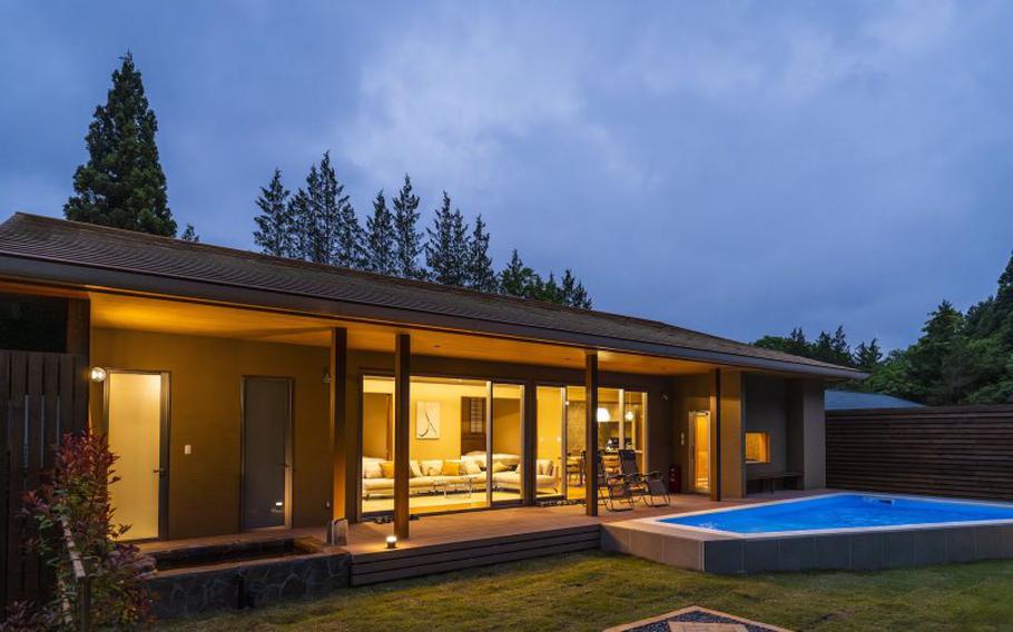 A hot spring bath and pool invite you outside, but warm and cosy lighting beckons you in.