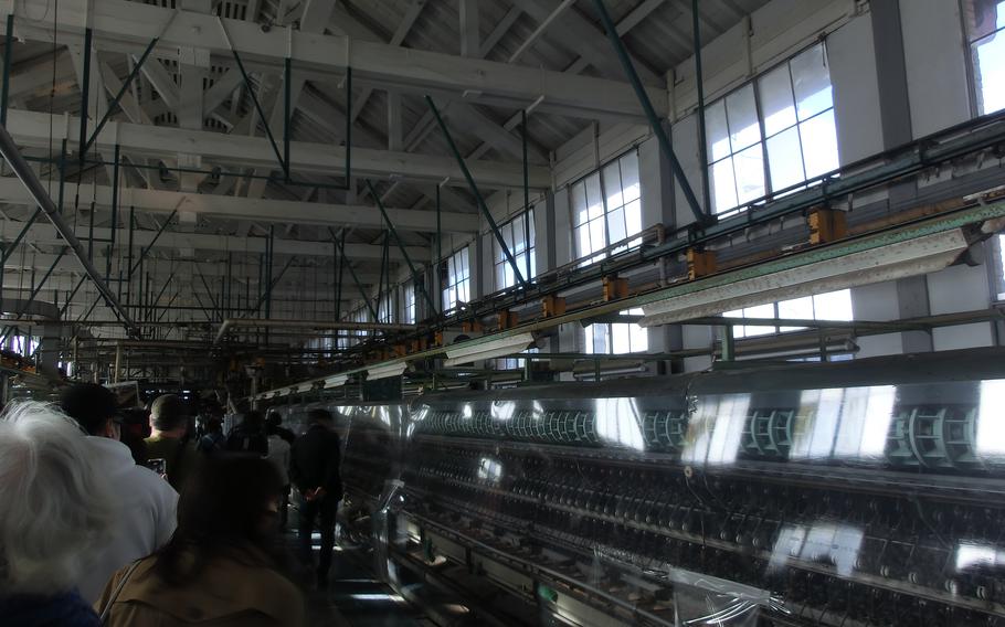 Visitors walking in the Silk-Reeling Plant.