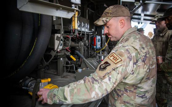 Photo Of Tech. Sgt. Peyton Passmore takes a closer look at a fuel hose.