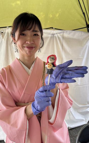 Candy artist holding a candy.