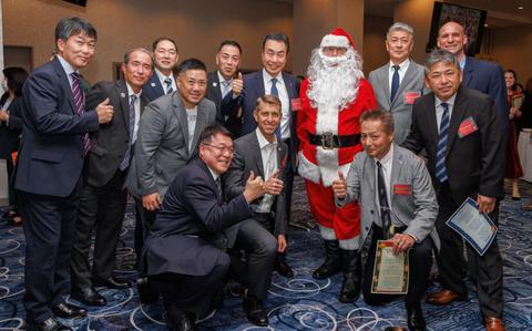 Photo Of Col. Marcus Hunter, center, commander of U.S. Army Garrison Japan, and Command Sgt. Maj. Rick Meeker, far right, garrison senior enlisted leader, pose for a photo with Japanese partners during a holiday reception at Camp Zama, Japan, Dec. 16, 2024. More than 200 local community leaders and Camp Zama personnel attended the event to celebrate the holiday season and their connections.